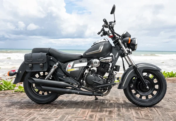 Black-and-chrome Benelli Motobi 200 Evo cruiser with round headlamp, low bench seat, long exhausts and side bags