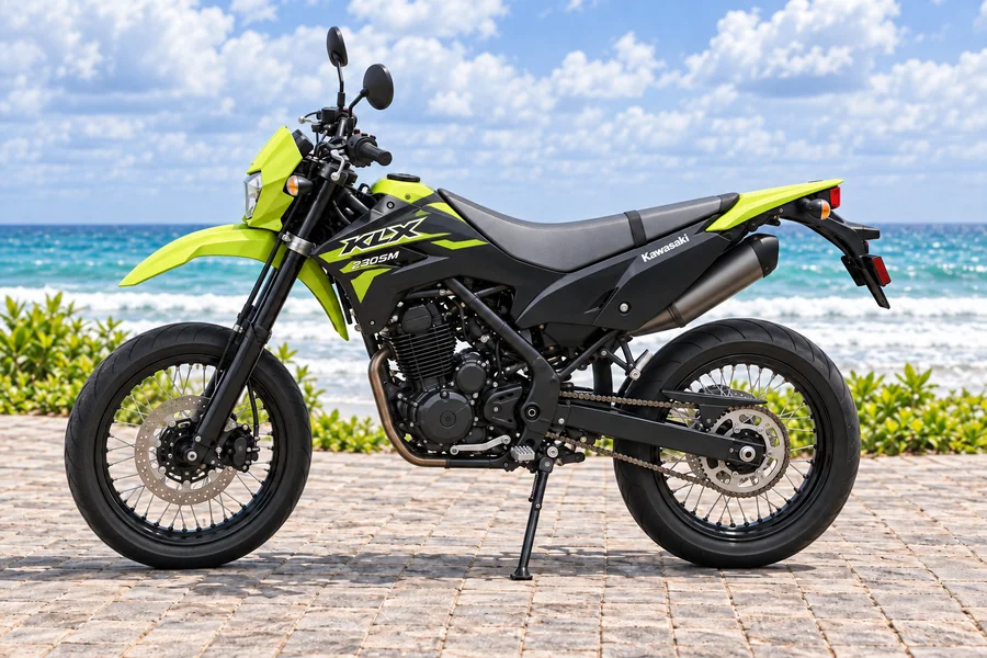 Neon-green and black Kawasaki KLX230 Supermoto, front-left view, beside the ocean