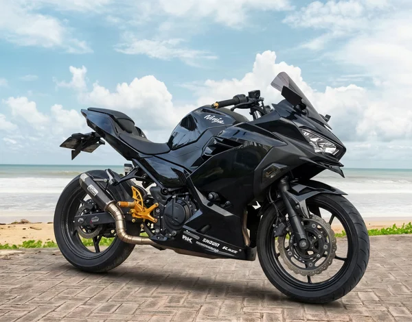 Black Kawasaki Ninja 250 Custom parallel-twin sport bike with full fairings and gold rearset details