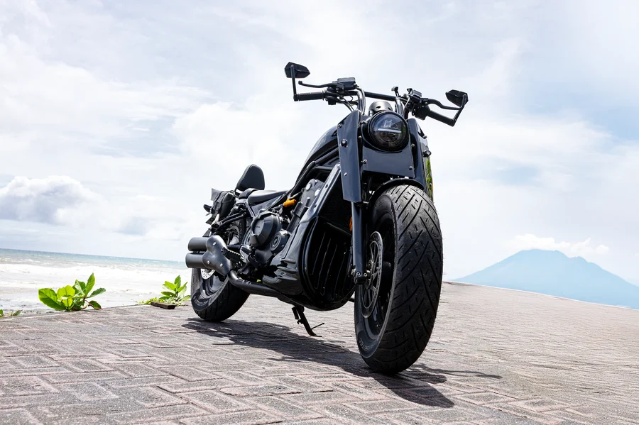Black Honda Rebel 500 custom chopper with comfortable rider seat, rear passenger seat and backrest, twin saddlebags and luggage rack