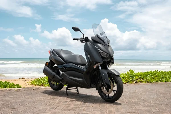 Black Yamaha XMAX 250 first-generation maxi scooter with tall windscreen and wide stepped seat