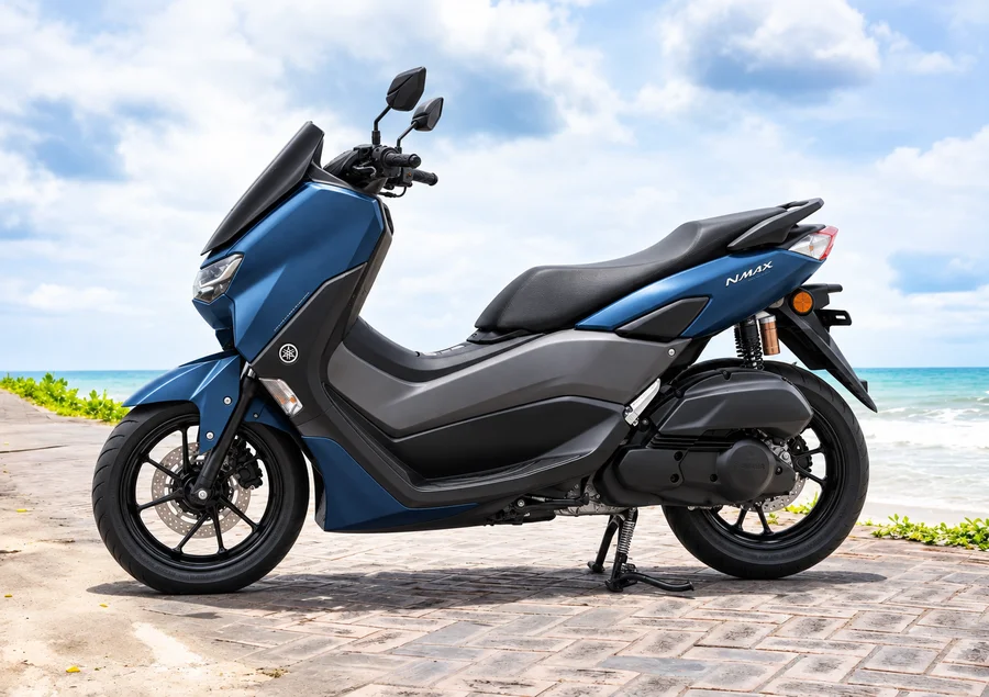 Blue second-generation Yamaha NMAX155, front-left view, beside the ocean