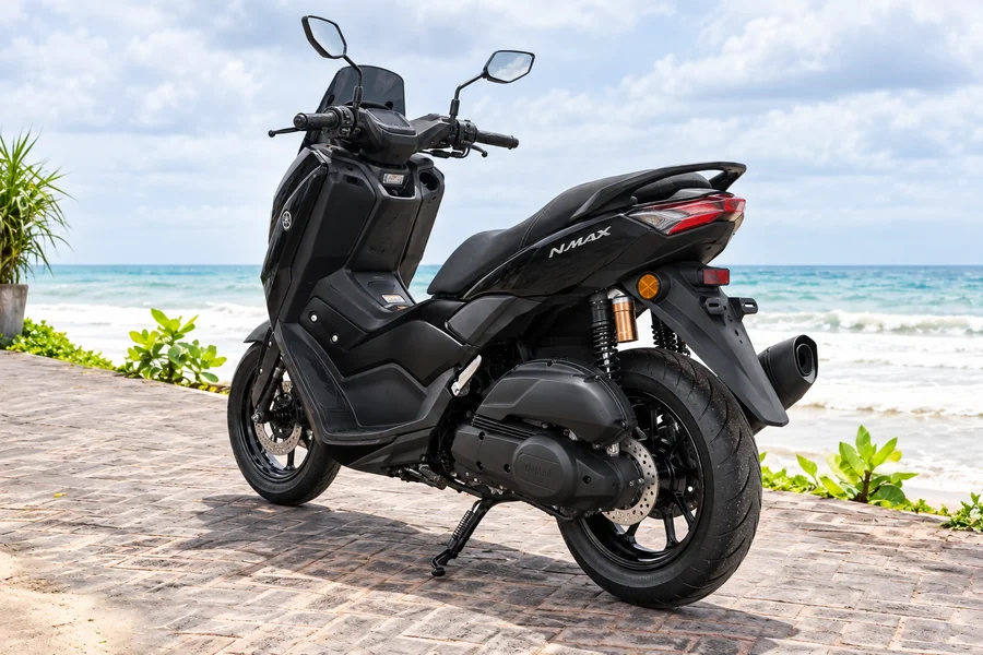 Black Yamaha NMAX155 Neo, front-left view, beside the ocean
