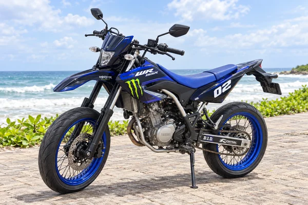 Blue Yamaha WR155R with supermoto road wheels, front three-quarter view