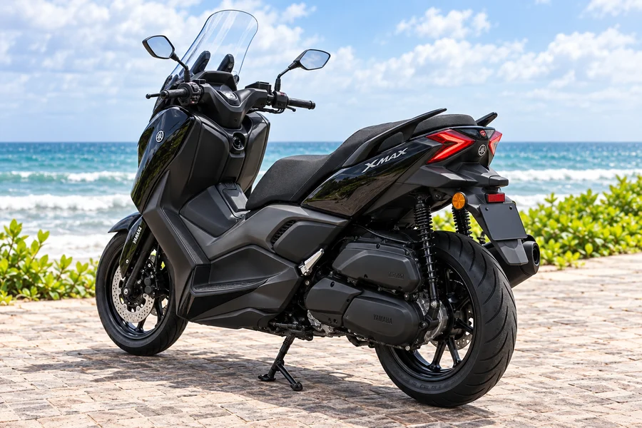 Black Yamaha XMAX 250 Connected, front-left view, beside the ocean