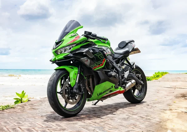 Green Kawasaki Ninja ZX-25R 250cc inline-four sport bike with full fairings and green wheels